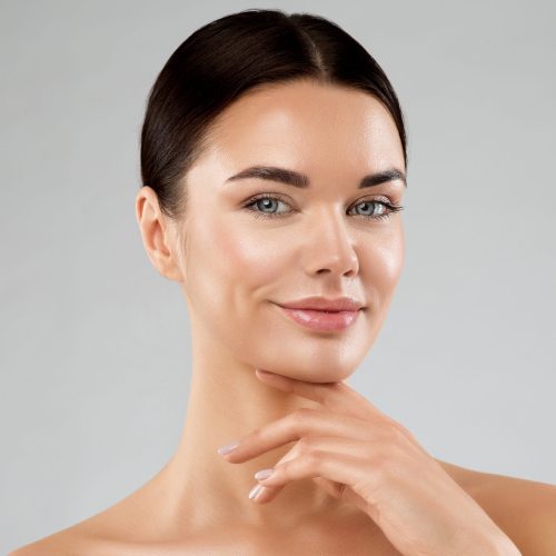 A young woman poses for the camera, showing off beautiful skin made possible by boosted collagen growth.